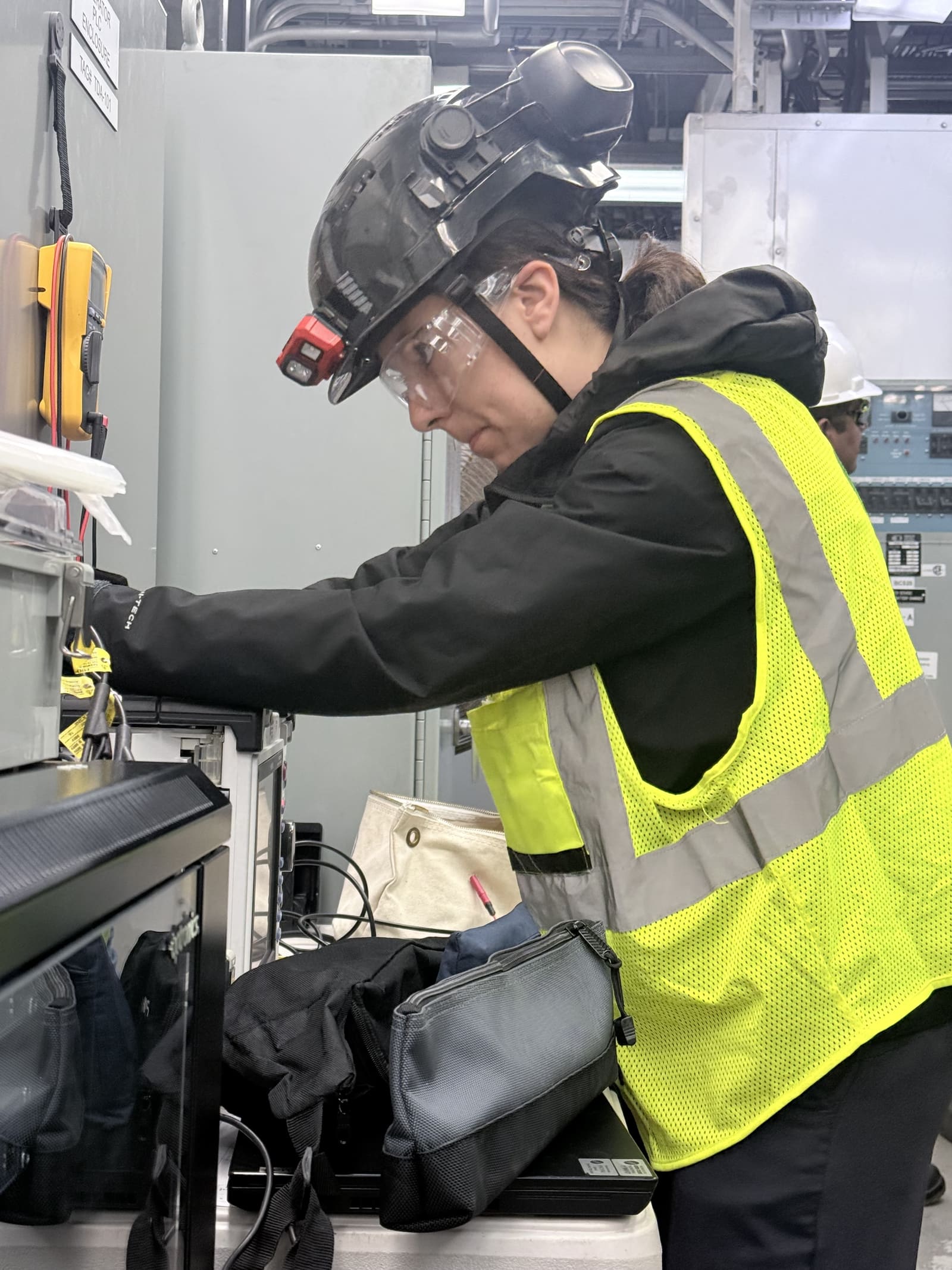 GCE field engineer connecting test equipment to a control panel during a live grid code campaign